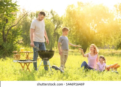 Happy family on summer picnic in park - Powered by Shutterstock