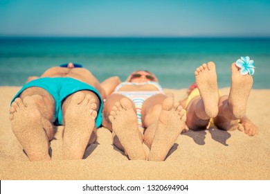Happy family on summer vacation. People lying on the beach. Healthy lifestyle concept