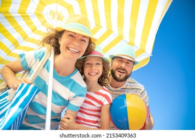 Happy family on summer vacation. Low angle view portrait of happy people against blue sky background - Shutterstock ID 2153409363