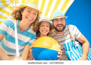 Happy family on summer vacation. Low angle view portrait of happy people against blue sky background - Shutterstock ID 2157201923