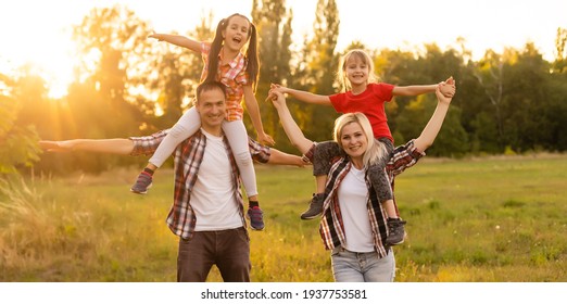 Happy Family On Sunset In Nature