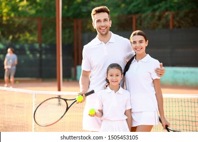 Happy Family On Tennis Court