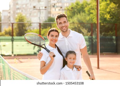 Happy Family On Tennis Court