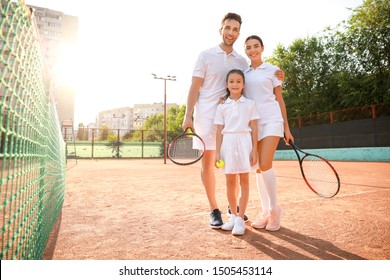 Happy Family On Tennis Court