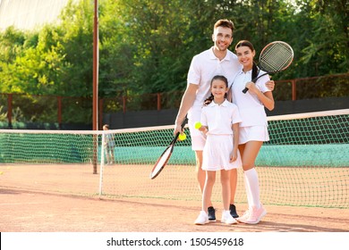 Happy Family On Tennis Court