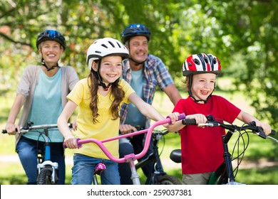 Happy family on their bike at the park on a sunny day