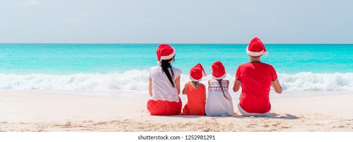 Happy Family On A Tropical Beach Celebrating Christmas Vacation