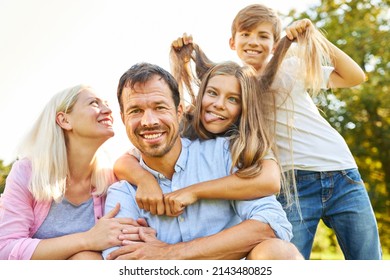 Happy Family On Vacation And Silly Kids Making Faces And Pulling Hair