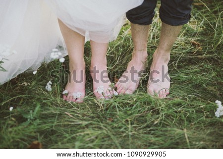 Happy Family on a Walk in Summer. Feet Barefoot on Green Grass. Healthy Lifestyle 