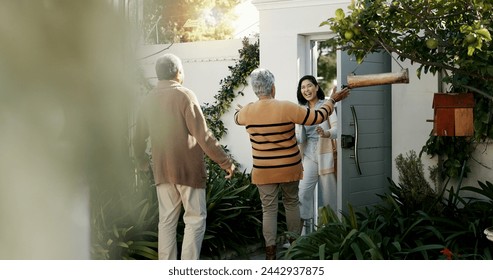 Happy family, open door and hug with flowers outdoor of home in backyard with daughter and parents with love. Reunion, welcome and woman with mom and dad, travel and surprise for holiday with embrace - Powered by Shutterstock