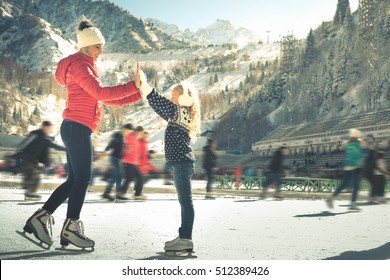 Happy Family Outdoor Ice Skating At Rink. Winter Activities