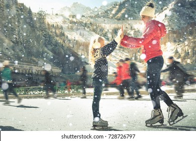 Happy Family Outdoor Ice Skating At Rink. Mother And Daughter Has Winter Activities. Mom, Kids. Medeo Stadium. Almaty.