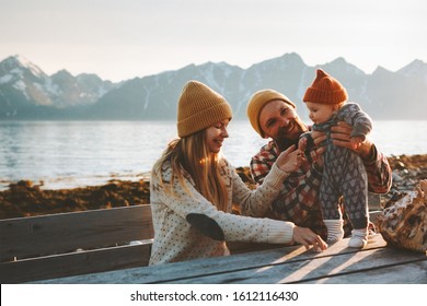 Happy family outdoor mother and father with baby traveling together vacation parents playing with child healthy lifestyle mountains view in Norway - Powered by Shutterstock