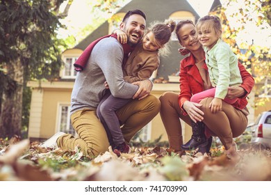 Happy Family Outside In Colorful Fall Backyard Poses To Camera. 