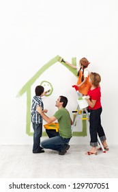 Happy Family Painting Their Home Together With The Kids