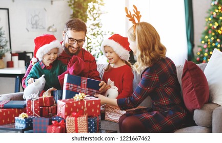 Happy Family Parents And Children Open Presents On Christmas Morning
