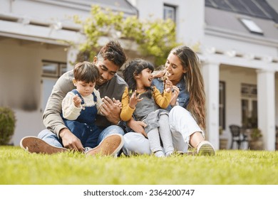 Happy family, parents and children for picnic, relax and games on grass or garden outdoor in summer. Love, people and kids at home on ground for care, freedom and bonding in nature or environment - Powered by Shutterstock