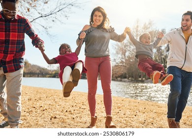 Happy family, parents and swing kids for adoption outdoor at lake for vacation, bonding or holding hands together. Interracial people, mother and father play game, support or laugh in nature at river - Powered by Shutterstock