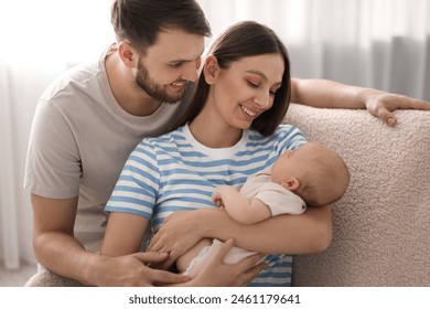 Happy family. Parents with their cute baby at home - Powered by Shutterstock