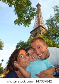 Happy Family In Paris Holidays. Eiffel Tower