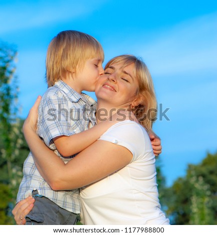 Similar – Image, Stock Photo Little boy kissing his mother on a field in summer