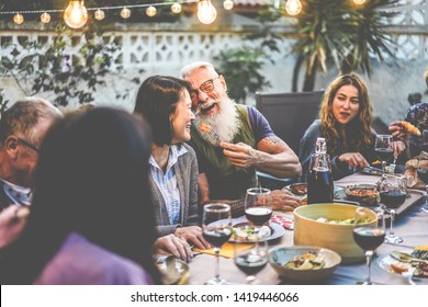 Happy Family People Having Fun At Barbecue Dinner - Multiracial Friends Eating At Bbq Meal - Food, Friendship, Relationship And Summer Lifestyle Concept - Focus On Hipster Man Face