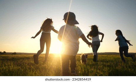 happy family. people in the park. children child running together in the park on grass silhouette. daughter and son are running. happy family and little child in summer. concept sunset dream