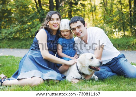 happy family with pet dog at picnic in a Sunny summer day. pregn