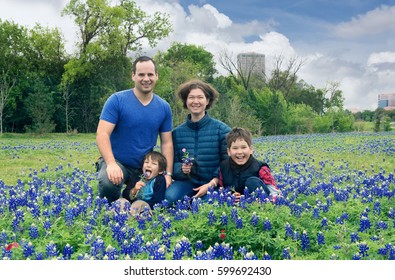 A Happy Family Is Photographed On The Field With Blooming Lupines. Bluebonnet (Lupinus Texensis), Or 