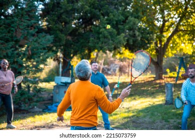 Happy Family Playing Badminton Game In The Sunny Autumn Backyard. Copy Space