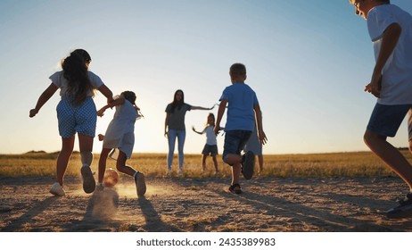 happy family playing ball in the park. group of children playing ball in nature. happy family kid dream concept. sunset children playing lifestyle soccer in the park in nature - Powered by Shutterstock