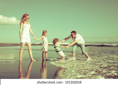 Happy Family Playing At The Beach In The Day Time