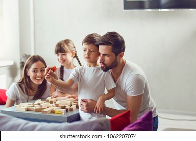 Happy Family Playing Board Games At Home.