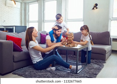 Happy family playing board games at home. 