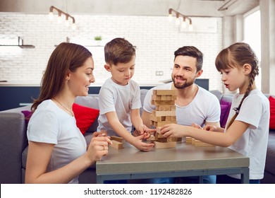 Happy Family Playing Board Games At Home. 