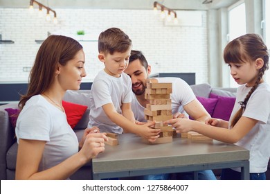 Happy Family Playing Board Games At Home. 