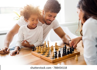 Happy Family Playing Chess Together