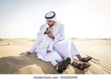 Happy Family Playing In The Desert Of Dubai -  Playful Father And His Son Having Fun Outdoors