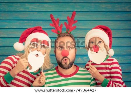 Happy family playing at home. Funny father; mother and child on Christmas eve. Xmas winter holiday concept