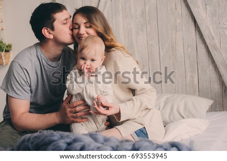 happy family playing at home on the bed