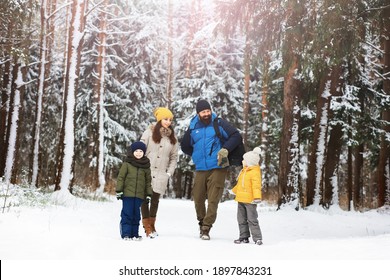 Happy Family Playing And Laughing In Winter Outdoors In Snow. City Park Winter Day.