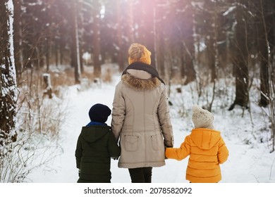 Happy Family Playing And Laughing In Winter Outdoors In Snow. City Park Winter Day.