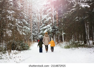 Happy Family Playing And Laughing In Winter Outdoors In Snow. City Park Winter Day.