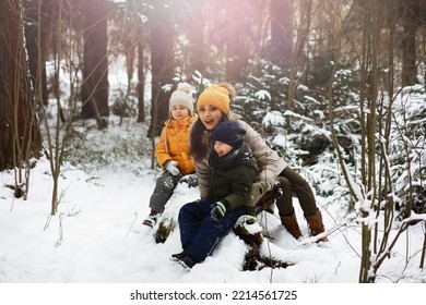 Happy Family Playing And Laughing In Winter Outdoors In Snow. City Park Winter Day.