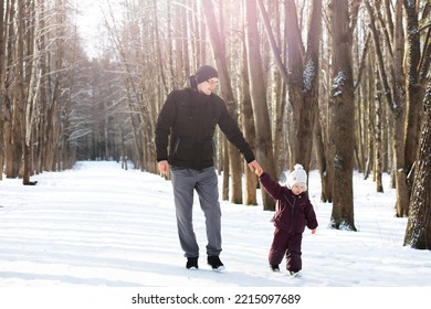 Happy Family Playing And Laughing In Winter Outdoors In Snow. City Park Winter Day.