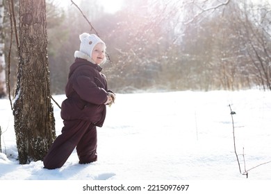 Happy Family Playing And Laughing In Winter Outdoors In Snow. City Park Winter Day.