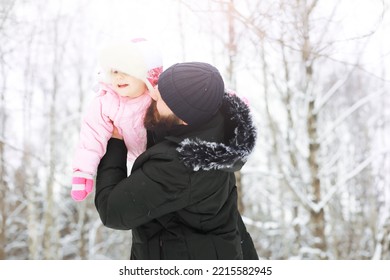 Happy Family Playing And Laughing In Winter Outdoors In Snow. City Park Winter Day.