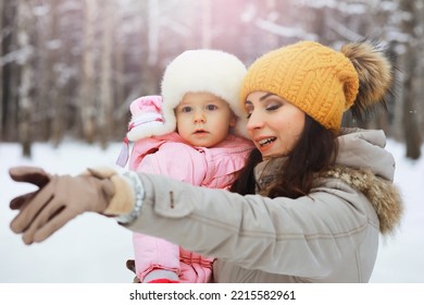 Happy Family Playing And Laughing In Winter Outdoors In Snow. City Park Winter Day.