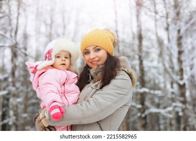 Happy Family Playing And Laughing In Winter Outdoors In Snow. City Park Winter Day.