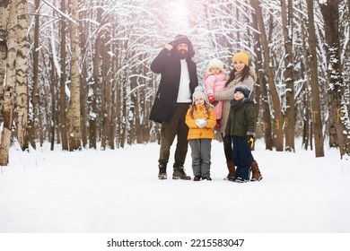 Happy Family Playing And Laughing In Winter Outdoors In Snow. City Park Winter Day.